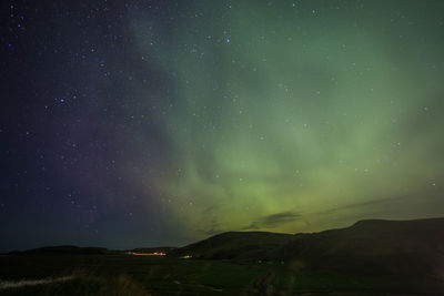 Scenic view of mountains against sky at night