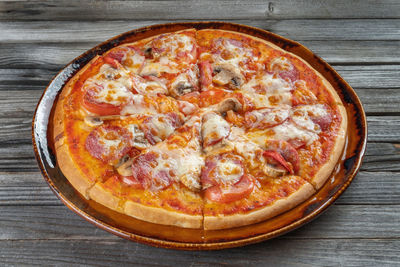 High angle view of pizza on wooden table