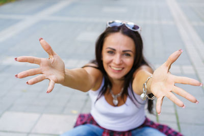 Portrait of young beautiful brunette woman with long hair in blue jeans