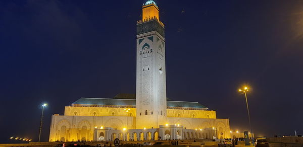 Low angle view of illuminated building against sky at night