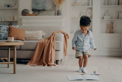 Full length of boy standing by book