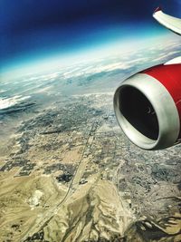 Cropped image of airplane flying over landscape