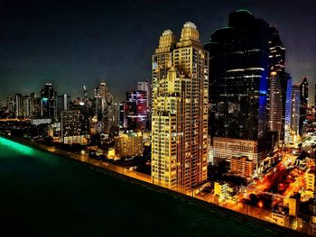 Illuminated buildings in city at night