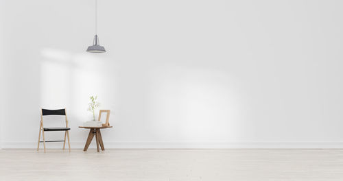 Empty chairs and table against wall at home