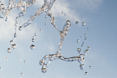 Close-up of water splashing against blue background