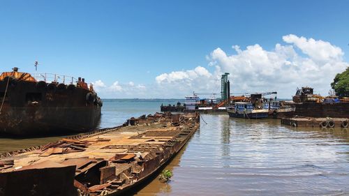 Boats moored on sea against sky