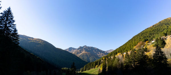 Scenic view of mountains against clear blue sky