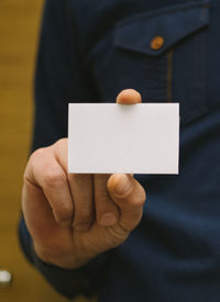 Close-up of person holding paper