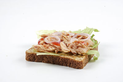 Close-up of bread in plate against white background