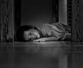 Portrait of cute boy lying on floor