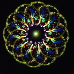 Close-up of illuminated lights over black background