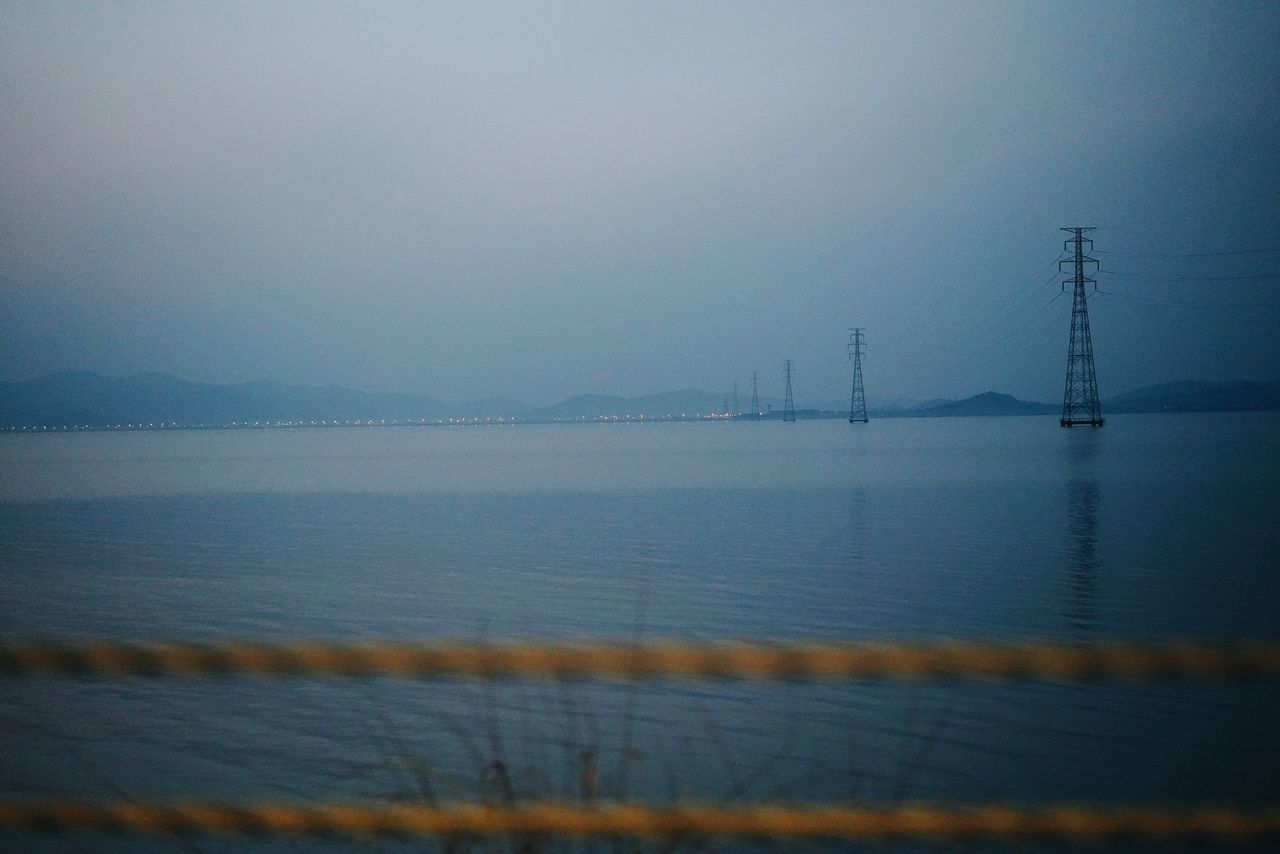 SCENIC VIEW OF BAY AGAINST SKY AT DUSK