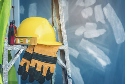 Close-up of yellow hat on wall