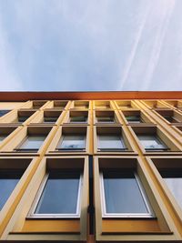 Low angle view of yellow building against sky