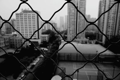 Close-up of chainlink fence against sky