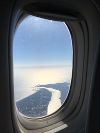 Scenic view of sea seen through airplane window