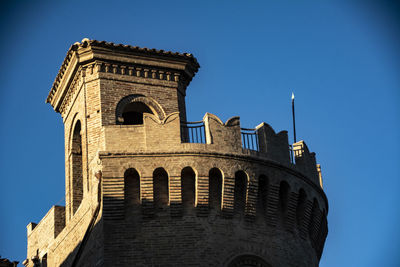 Low angle view of historical building against blue sky