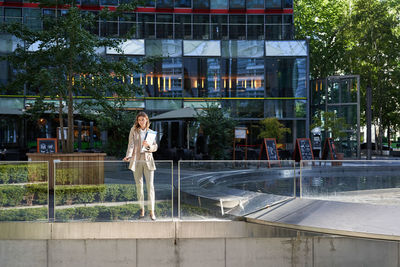 Rear view of woman standing in park