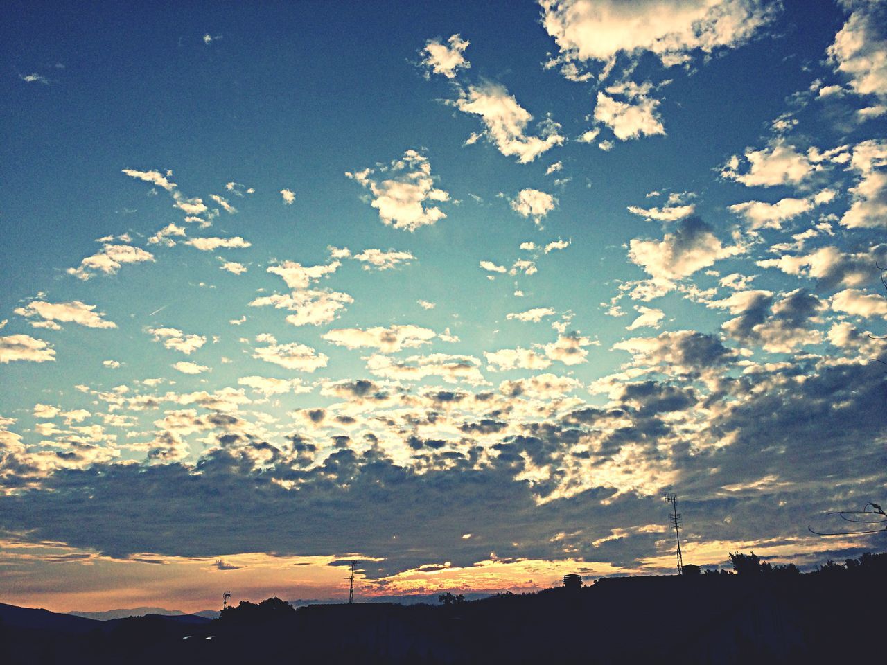 sky, beauty in nature, silhouette, scenics, tranquility, tranquil scene, cloud - sky, low angle view, nature, sunset, landscape, blue, cloud, idyllic, outdoors, no people, dusk, cloudy, sunlight, non-urban scene