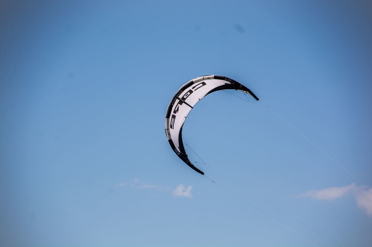 LOW ANGLE VIEW OF PARAGLIDING AGAINST BLUE SKY