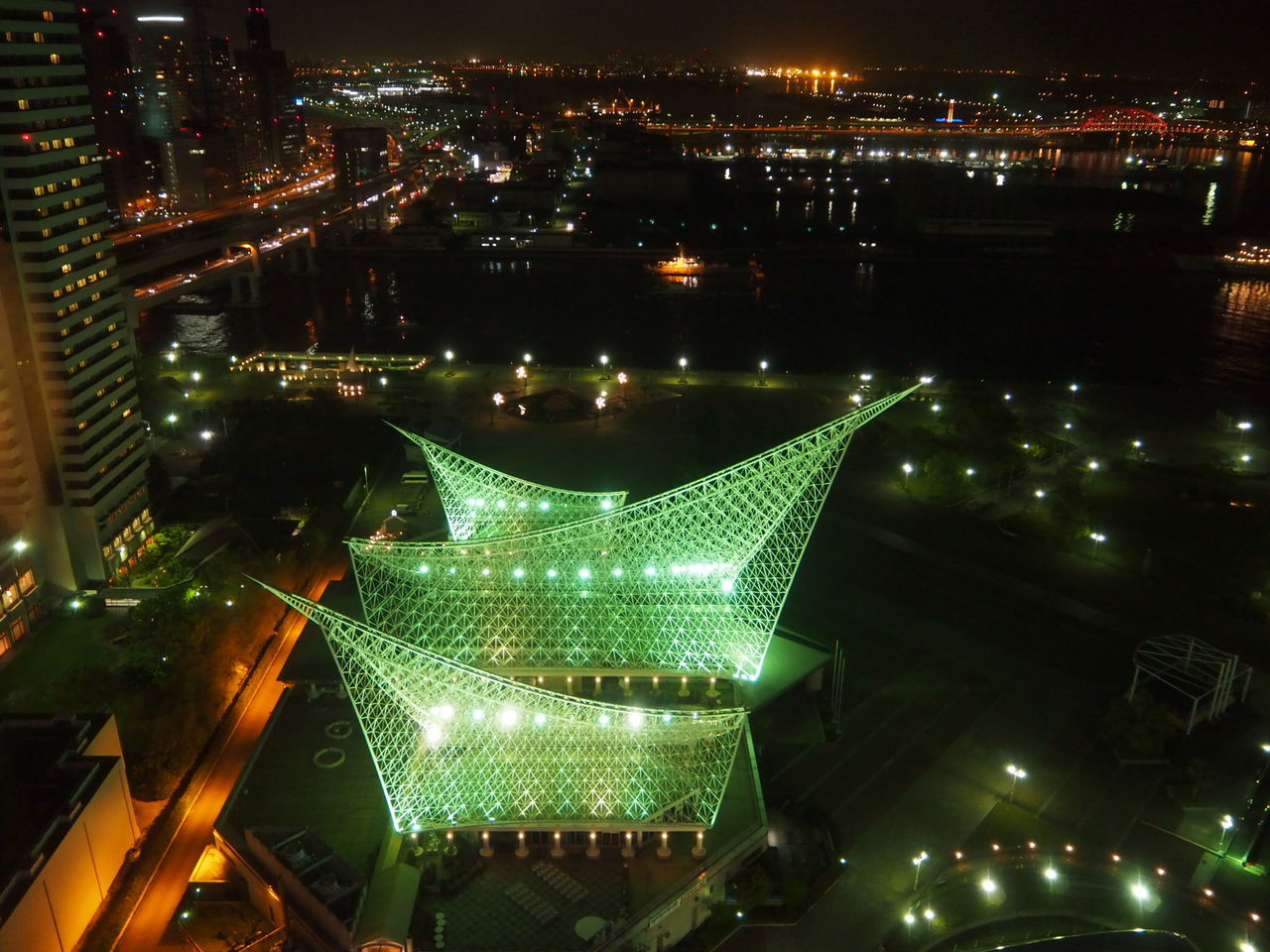 illuminated, night, building exterior, architecture, city, built structure, cityscape, lighting equipment, high angle view, modern, city life, skyscraper, light - natural phenomenon, light trail, glowing, residential building, street light, outdoors, sky, office building