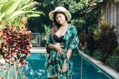 Young woman standing in swimming pool