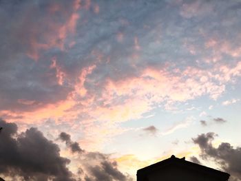 High section of building against sky at sunset