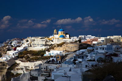 High angle view of town against blue sky