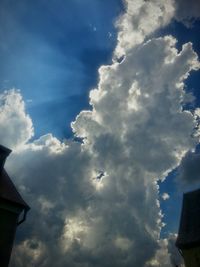 Low angle view of building against cloudy sky