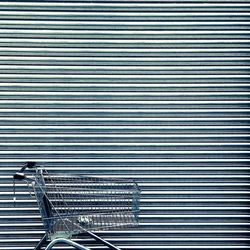 Shopping cart against closed shutter