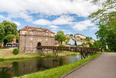 Arch bridge over river against buildings