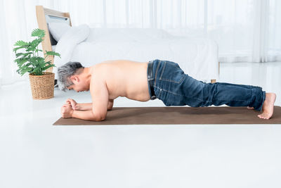 Man lying on sofa at home