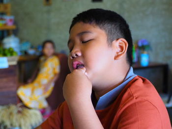 Portrait of boy sitting at home