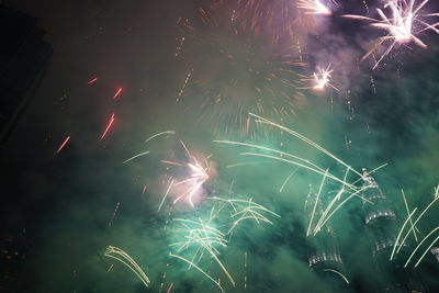 Low angle view of firework display at night
