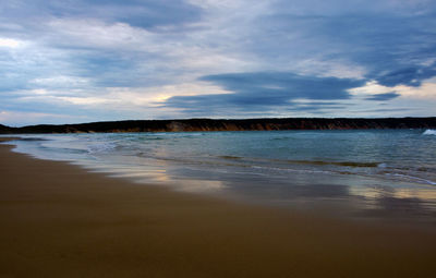 Scenic view of sea against cloudy sky