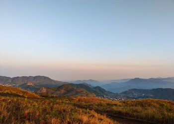 Scenic view of mountains against clear sky during sunrise