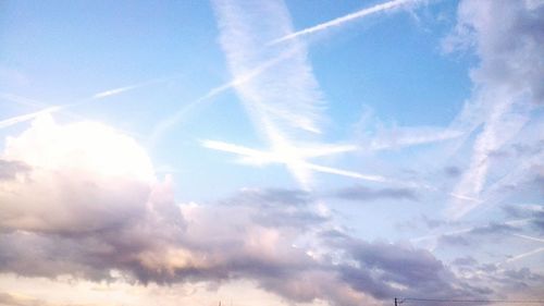 Low angle view of vapor trails in sky