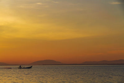 Silhouette of fisherman catching fish early in the morning at laem ta chi, pattani, thailand