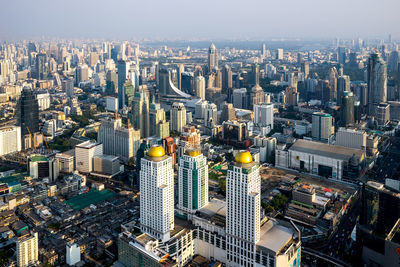 High angle view of modern buildings in city against sky