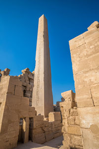 Low angle view of historical building against clear blue sky