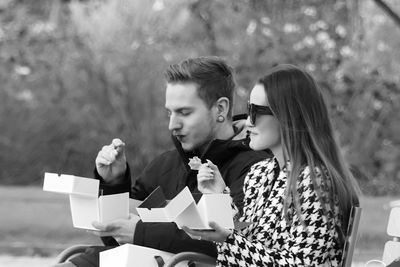 Young couple sitting outdoors