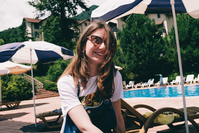 Portrait of smiling young woman in swimming pool