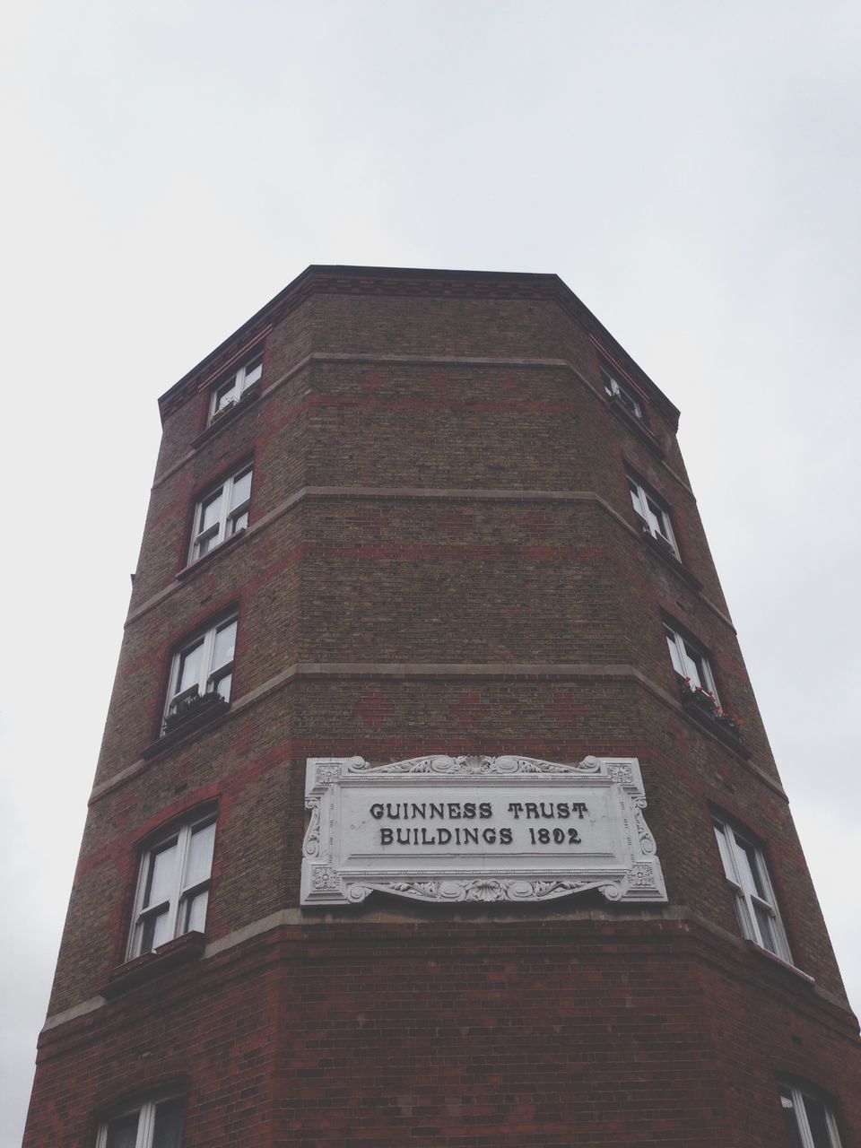 architecture, building exterior, built structure, low angle view, clear sky, building, window, sky, day, residential structure, outdoors, no people, residential building, city, copy space, red, wall - building feature, house, brick wall, part of