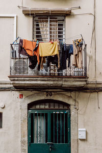 Low angle view of clothes hanging at building balcony