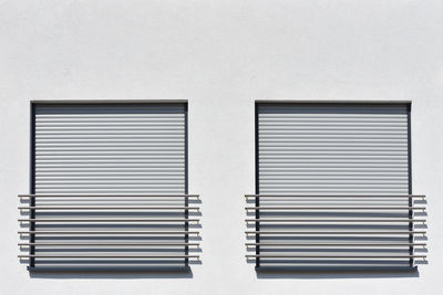 Close-up of window roller shutters  on white wall