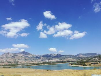 Scenic view of river with mountains in background