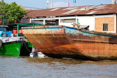 Boat moored in sea against buildings