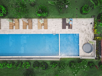 Aerial view of attractive woman near the pool at resort