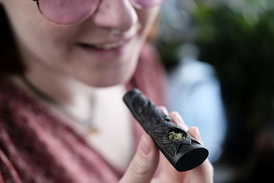 Close-up of woman holding weed