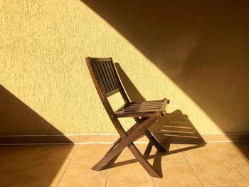 Minimalistic shot of wooden chair sitting in the bright sunlight